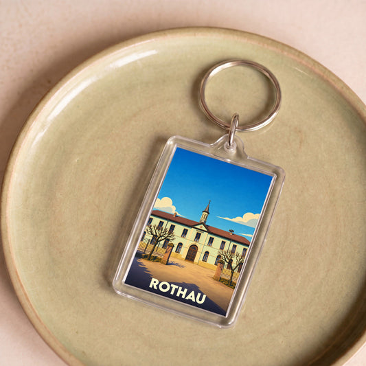 Porte-clés souvenir de la ville de Rothau avec une illustration stylisée de son architecture.
