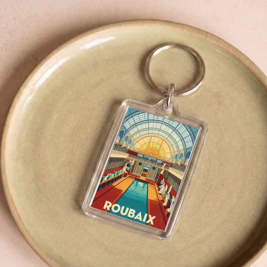 Porte-clés souvenir de la ville de Roubaix avec une illustration stylisée.