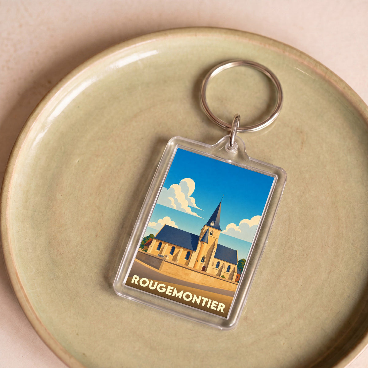Porte-clés souvenir de la ville de Rougemontier avec une illustration stylisée de son église.