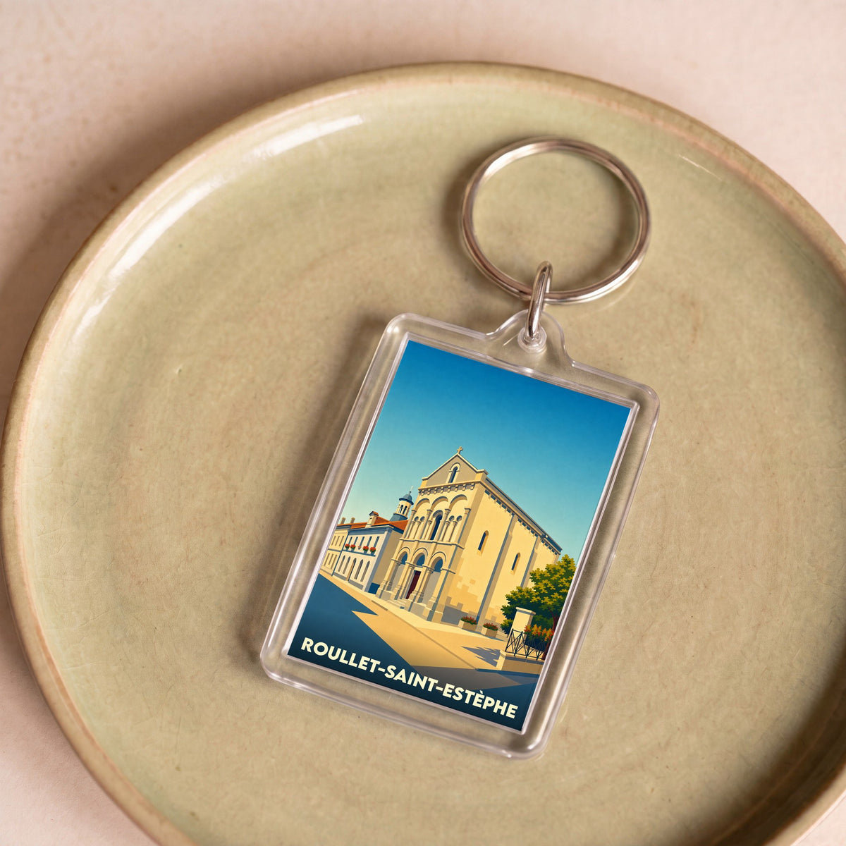 Porte-clés souvenir de la ville de Roullet-Saint-Estèphe avec une illustration stylisée.