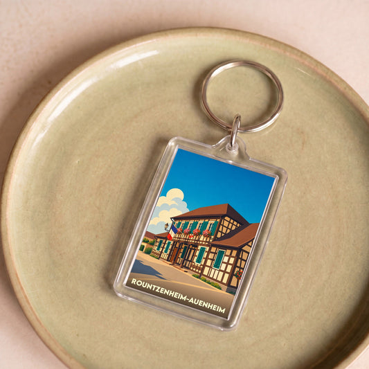 Porte-clés souvenir de la ville de Rountzenheim-Auenheim avec une illustration stylisée d'une maison à colombages.