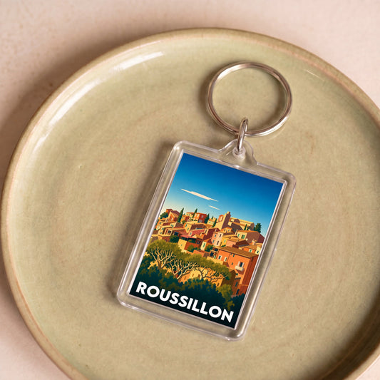 Porte-clés souvenir de la ville de Roussillon avec une illustration stylisée.