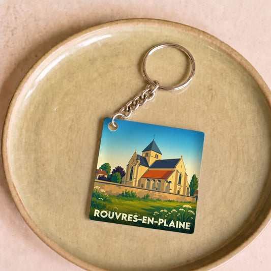 Porte-clés souvenir de la ville de Rouvres-en-Plaine avec une illustration stylisée de son église.