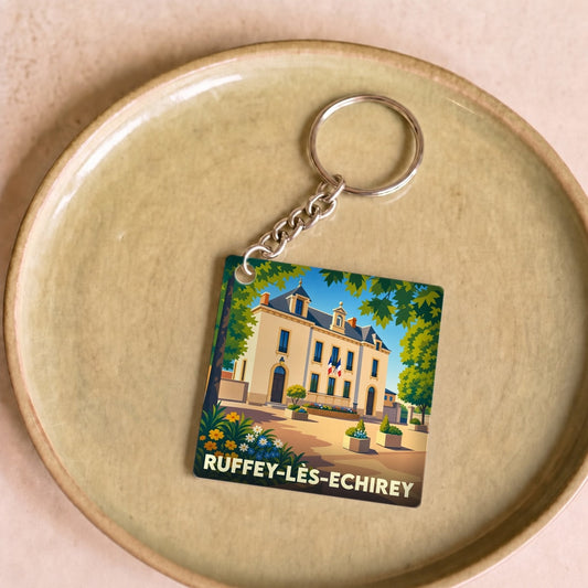 Porte-clés souvenir de la ville de Ruffey-lès-Echirey avec une illustration stylisée.