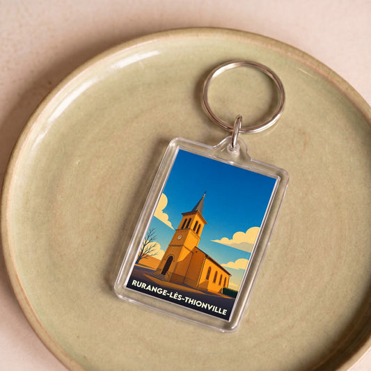 Porte-clés souvenir de la ville de Rurange-lès-Thionville avec une illustration stylisée de son église.