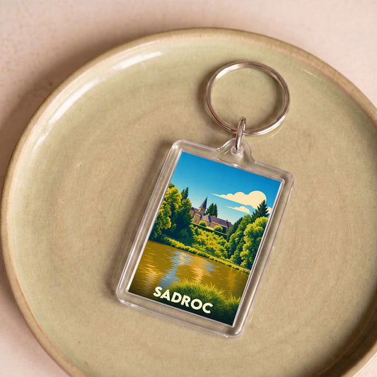 Porte-clés souvenir de la ville de Sadroc avec une illustration stylisée.