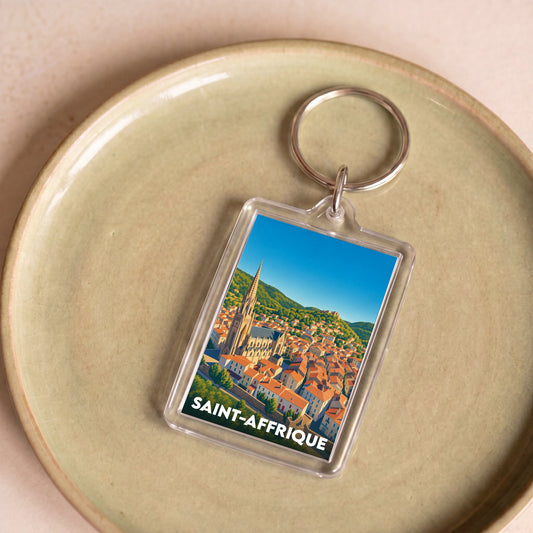 Porte-clés souvenir de la ville de Saint-Affrique avec une illustration colorée et stylisée.
