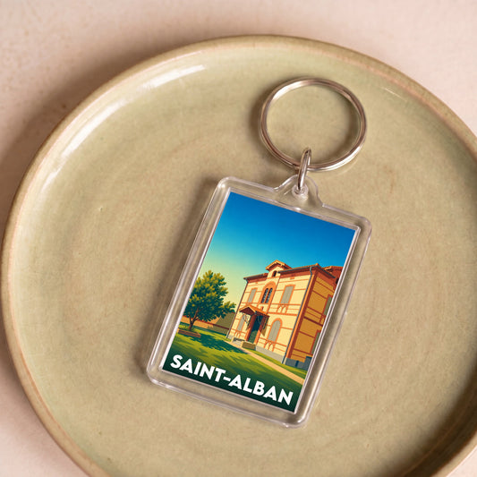 Porte-clés souvenir de la ville de Saint-Alban avec une illustration stylisée d'un bâtiment historique.