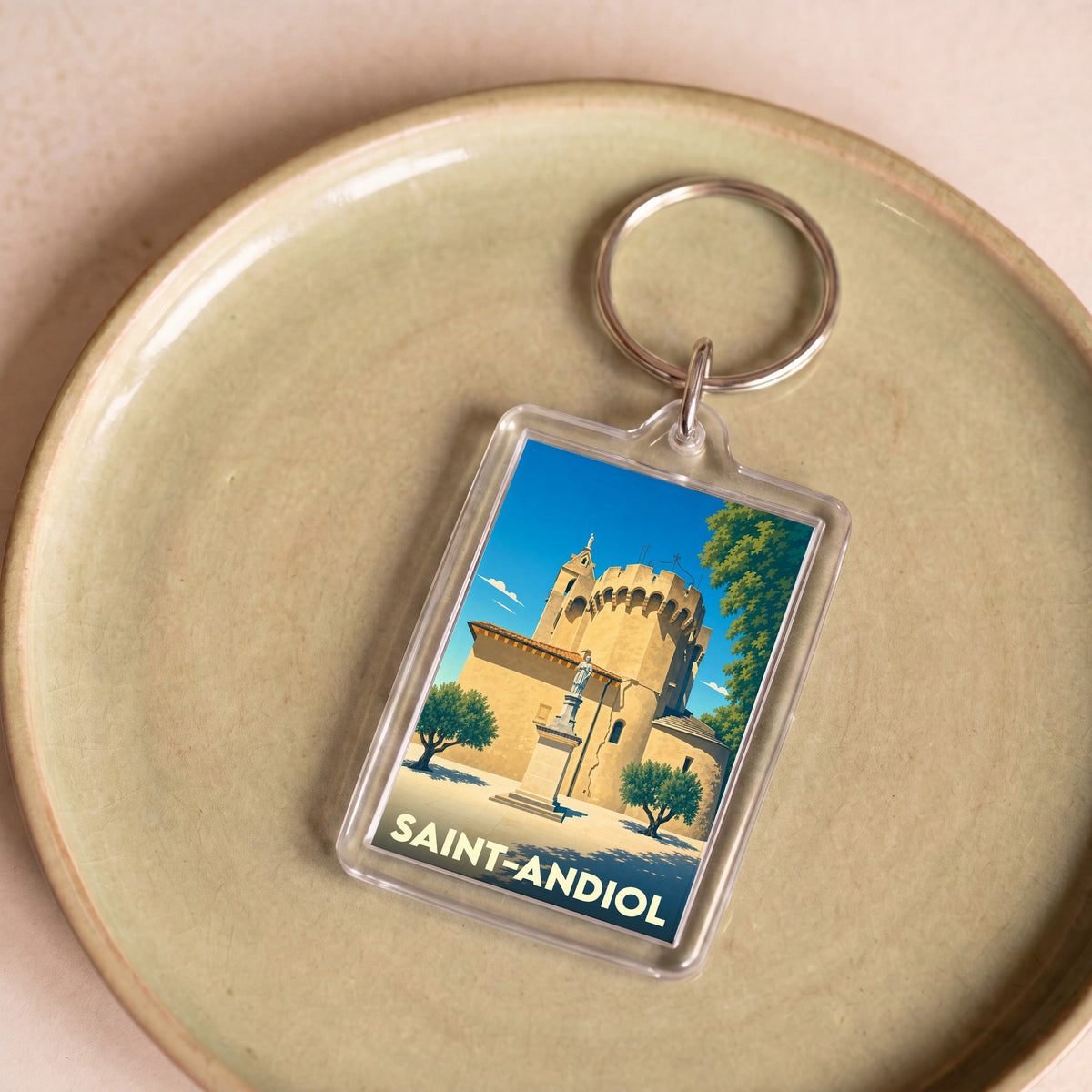 Porte-clés souvenir de la ville de Saint-Andiol avec une illustration stylisée.