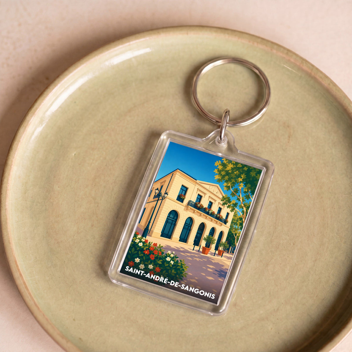 Porte-clés souvenir de la ville de Saint-André-de-Sangonis avec une illustration stylisée.