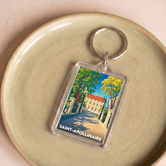 Porte-clés souvenir de la ville de Saint-Apollinaire avec une illustration stylisée d'un bâtiment historique.
