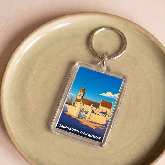 Porte-clés souvenir de la ville de Saint-Aubin-d'Arquenay avec une illustration stylisée de son église.