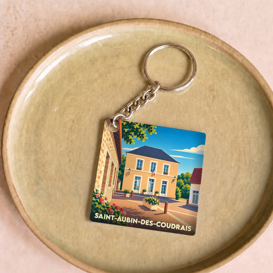 Porte-clés souvenir de la ville de Saint-Aubin-des-Coudrais avec une illustration stylisée.