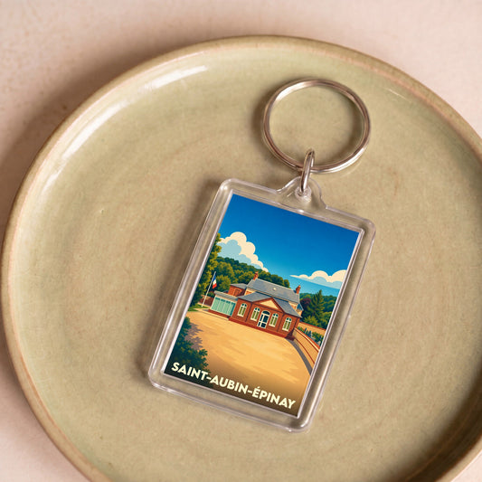 Porte-clés souvenir de la ville de Saint-Aubin-Épinay avec une illustration stylisée.