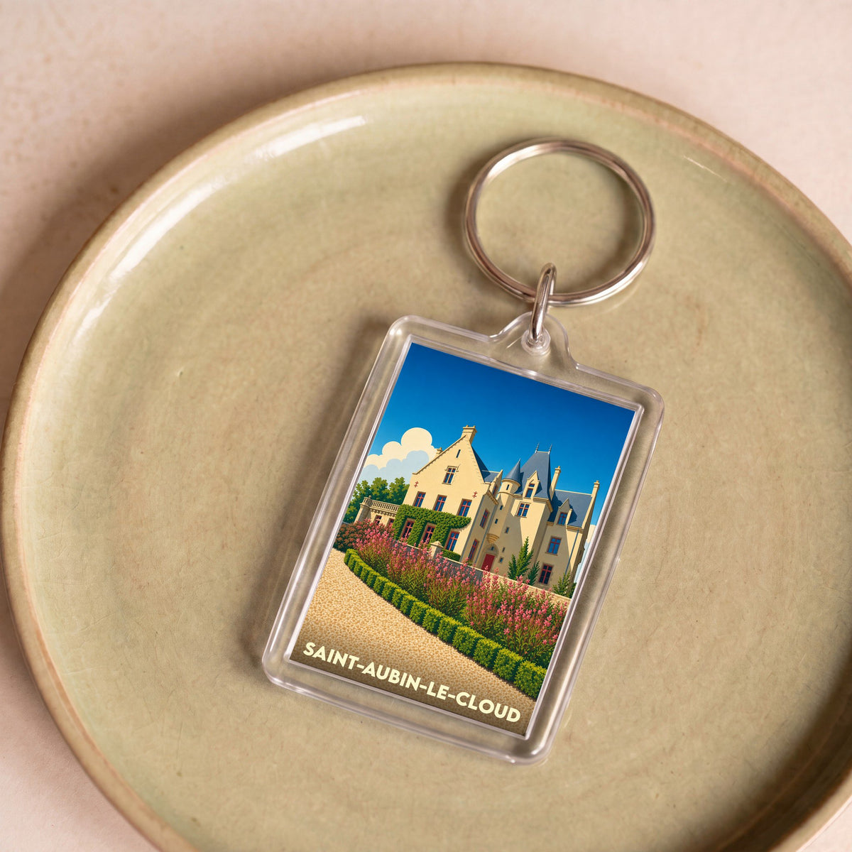 Porte-clés souvenir de la ville de Saint-Aubin-le-Cloud avec une illustration stylisée de château.