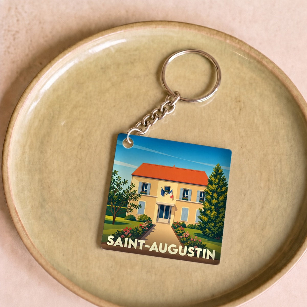 Porte-clés souvenir de la ville de Saint-Augustin avec une illustration stylisée d'une maison régionale.