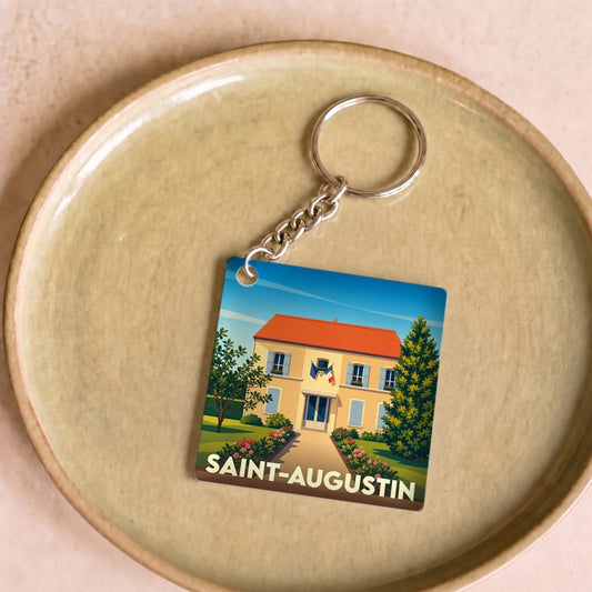 Porte-clés souvenir de la ville de Saint-Augustin avec une illustration stylisée d'une maison régionale.