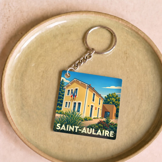 Porte-clés souvenir de la ville de Saint-Aulaire avec une illustration stylisée de sa mairie.