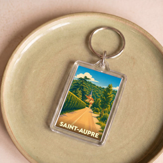 Porte-clés souvenir de la ville de Saint-Aupre avec une illustration stylisée d'un paysage local.