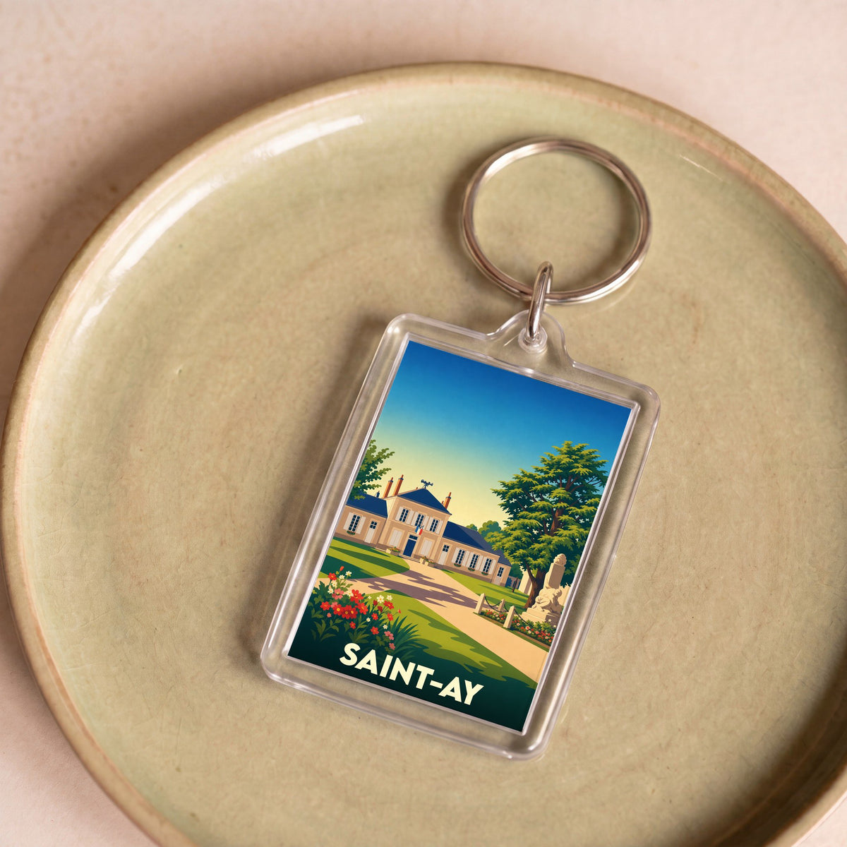 Porte-clés souvenir de la ville de Saint-Ay avec une illustration stylisée de son patrimoine.