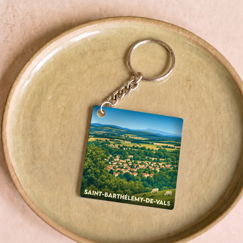 Porte-clés souvenir de la ville de Saint-Barthélemy-de-Vals avec une illustration stylisée du village et de sa campagne.