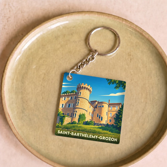 Porte-clés souvenir de la ville de Saint-Barthélemy-Grozon avec une illustration stylisée de son château.