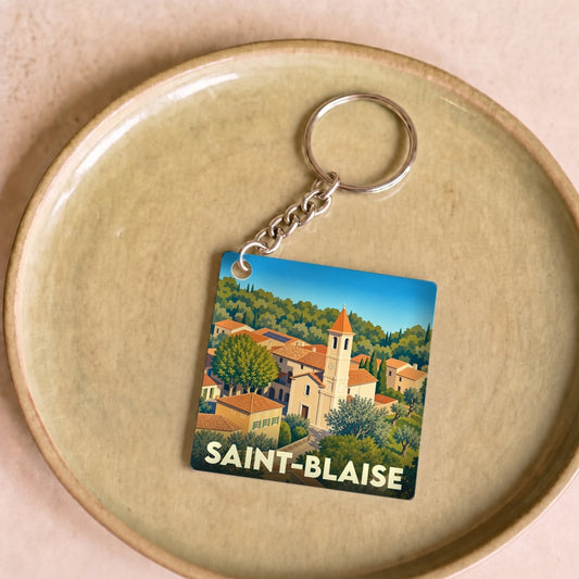 Porte-clés souvenir de la ville de Saint-Blaise avec une illustration stylisée.