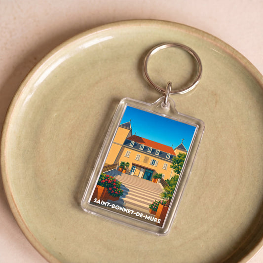 Porte-clés souvenir de la ville de Saint-Bonnet-de-Mure avec une illustration stylisée.