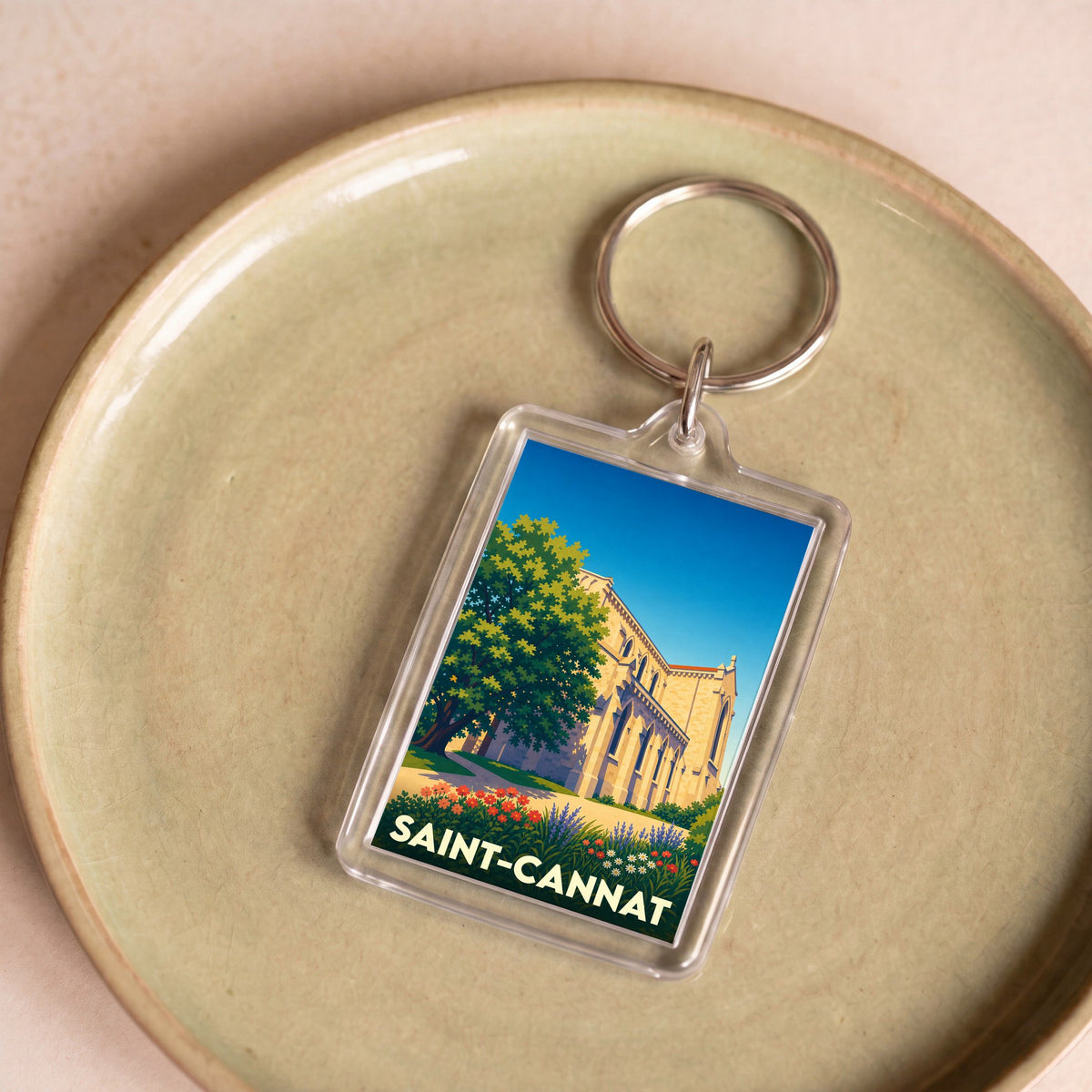 Porte-clés souvenir de la ville de Saint-Cannat avec une illustration stylisée de son église.