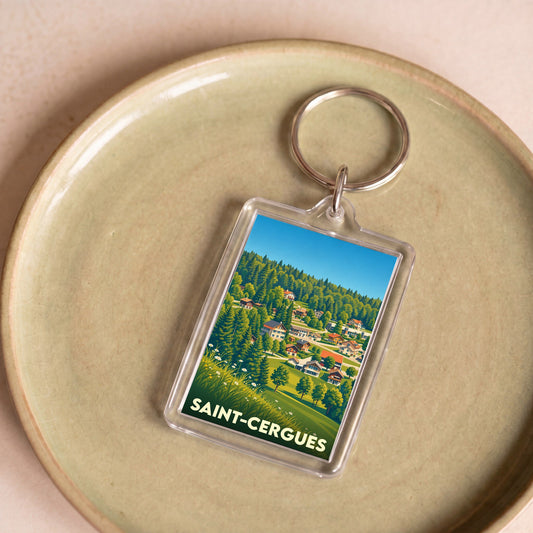 Porte-clés souvenir de la ville de Saint-Cergues avec une illustration stylisée de son paysage vallonné.