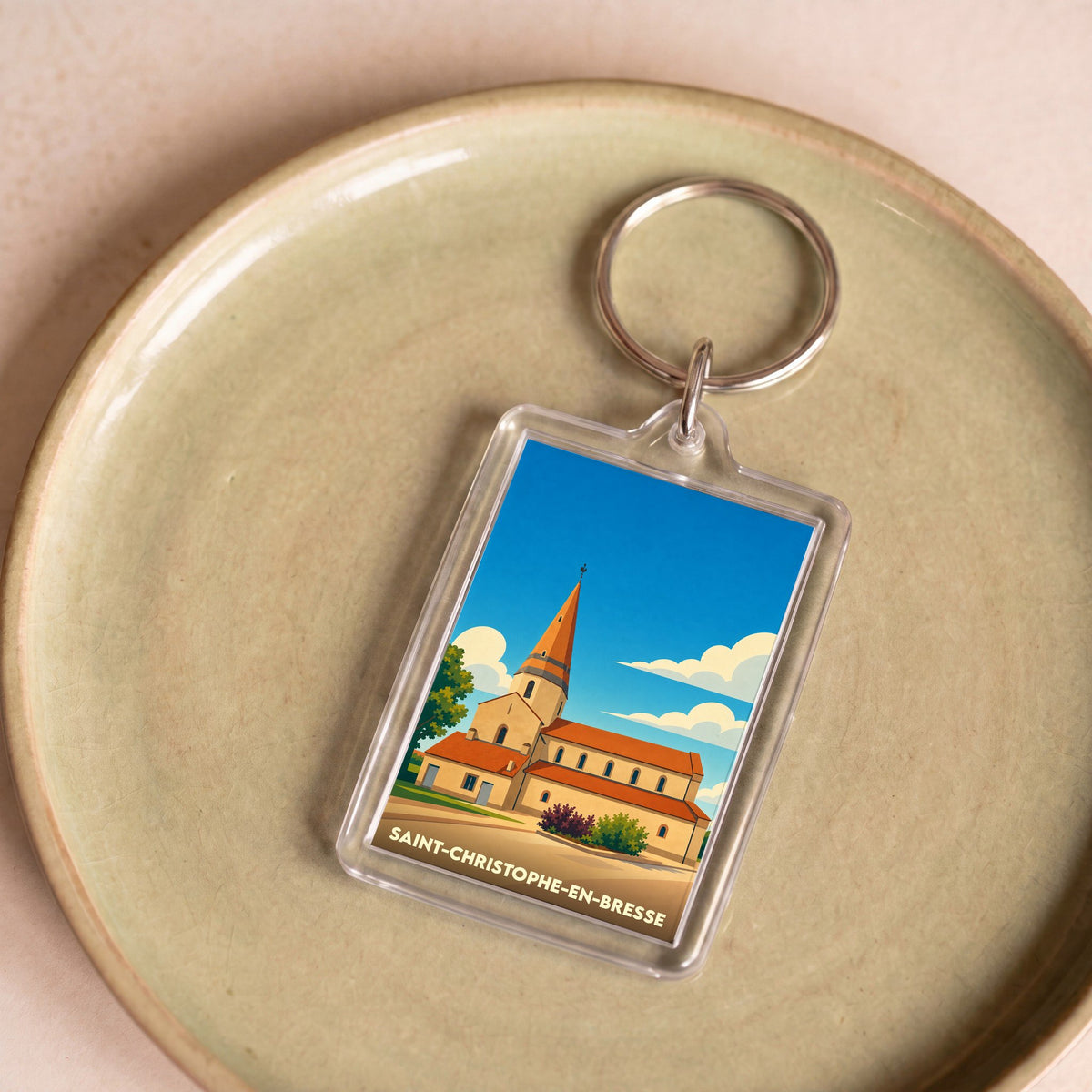 Porte-clés souvenir de Saint-Christophe-en-Bresse avec une illustration stylisée de son église.