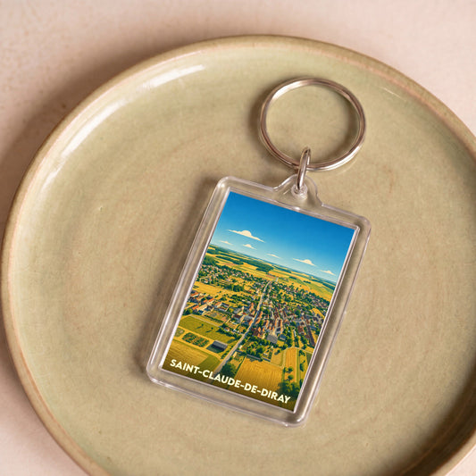Porte-clés souvenir de la ville de Saint-Claude-de-Diray avec une illustration stylisée vue du ciel.