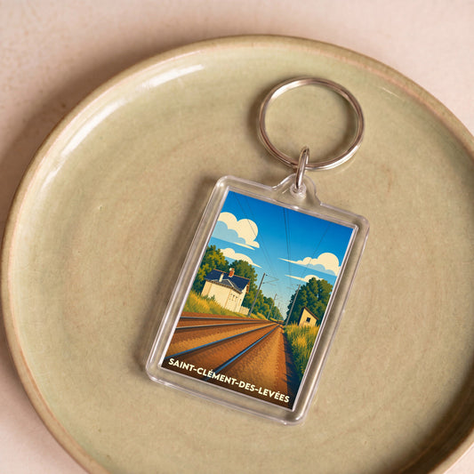 Porte-clés souvenir de la ville de Saint-Clément-des-Levées avec une illustration stylisée d'une voie ferrée.