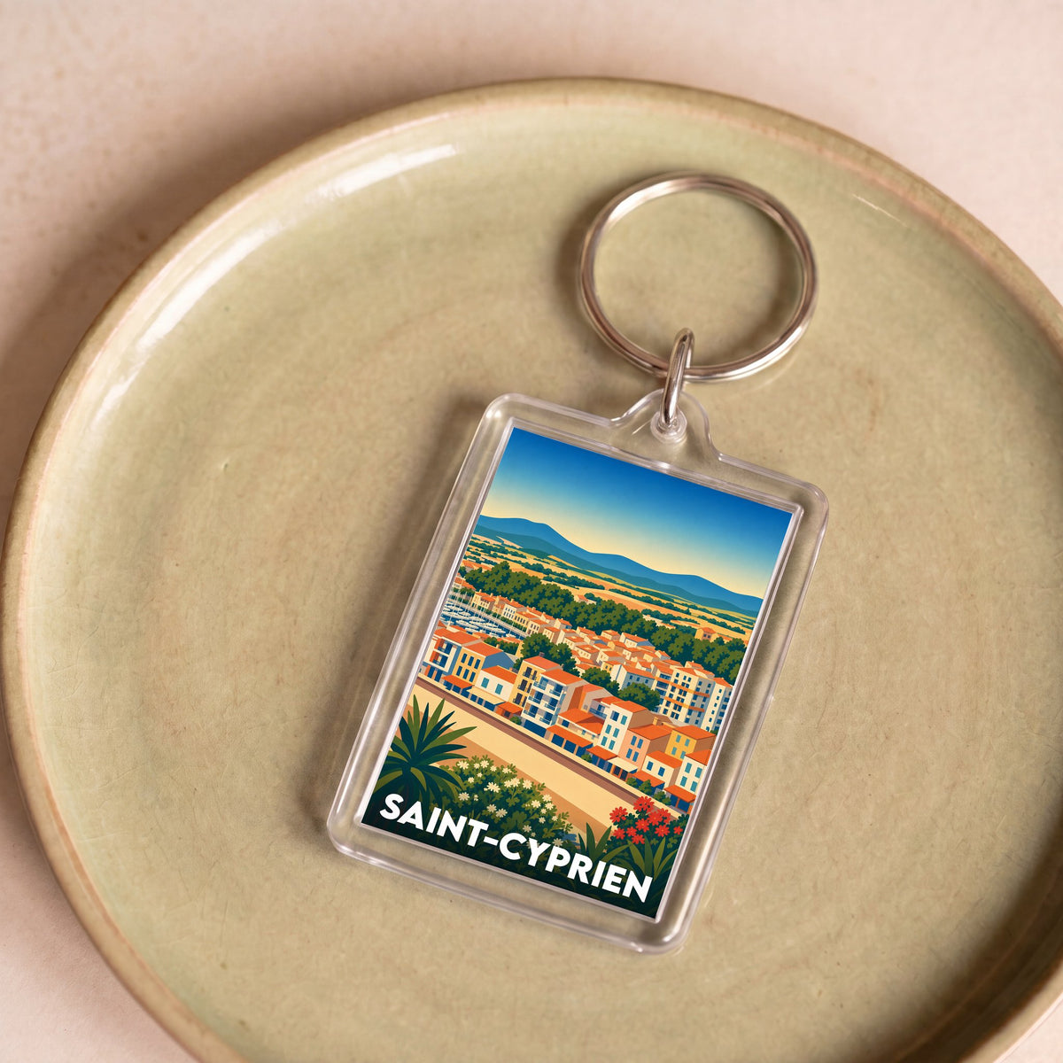 Porte-clés souvenir de la ville de Saint-Cyprien avec une illustration stylisée.
