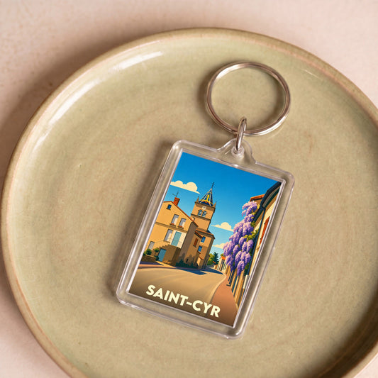 Porte-clés souvenir de la ville de Saint-Cyr avec une illustration stylisée.