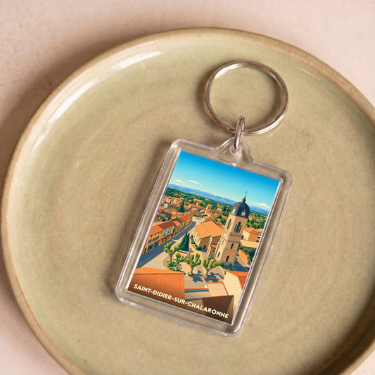 Porte-clés souvenir de la ville de Saint-Didier-sur-Chalaronne avec une illustration stylisée.