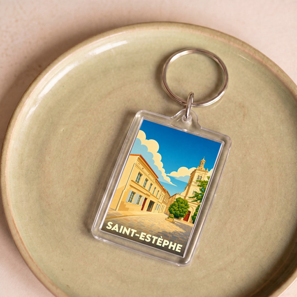 Porte-clés souvenir de la ville de Saint-Estèphe avec une illustration stylisée.