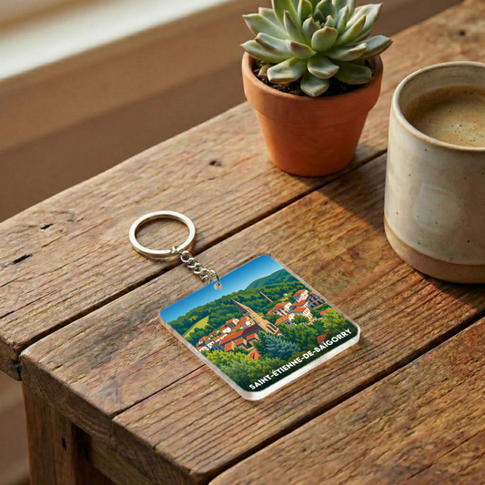 Porte-clés souvenir de la ville de Saint-Étienne-de-Baïgorry avec une illustration stylisée.