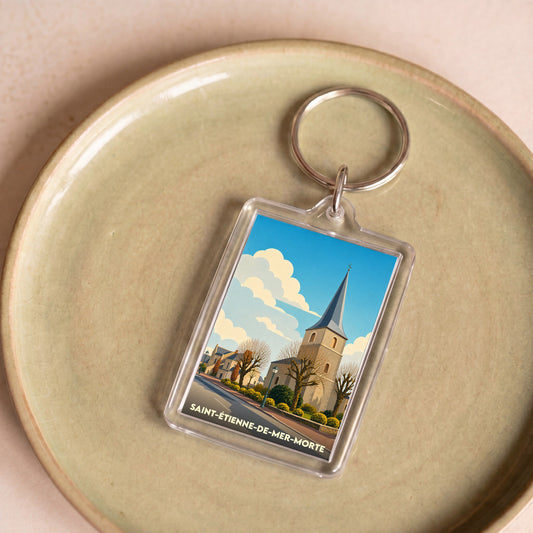 Porte-clés souvenir de la ville de Saint-Étienne-de-Mer-Morte avec une illustration stylisée de son église.