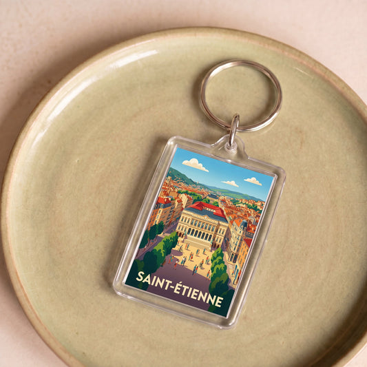 Porte-clés souvenir de la ville de Saint-Étienne avec une illustration stylisée.