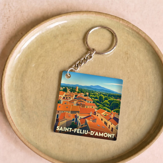 Porte-clés souvenir de la ville de Saint-Féliu-d'Amont avec une illustration stylisée.