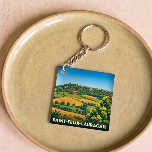 Porte-clés souvenir de la ville de Saint-Félix-Lauragais avec une illustration stylisée.