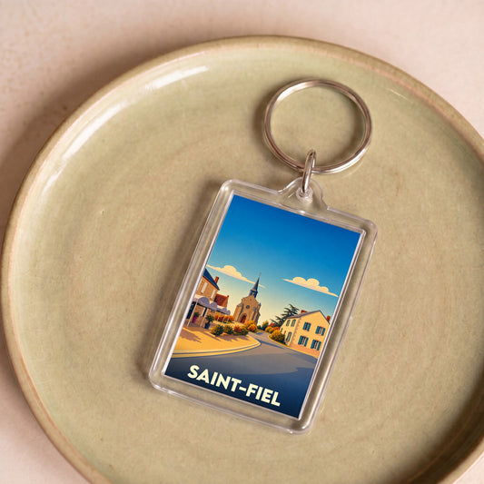 Porte-clés souvenir de la ville de Saint-Fiel avec une illustration stylisée.