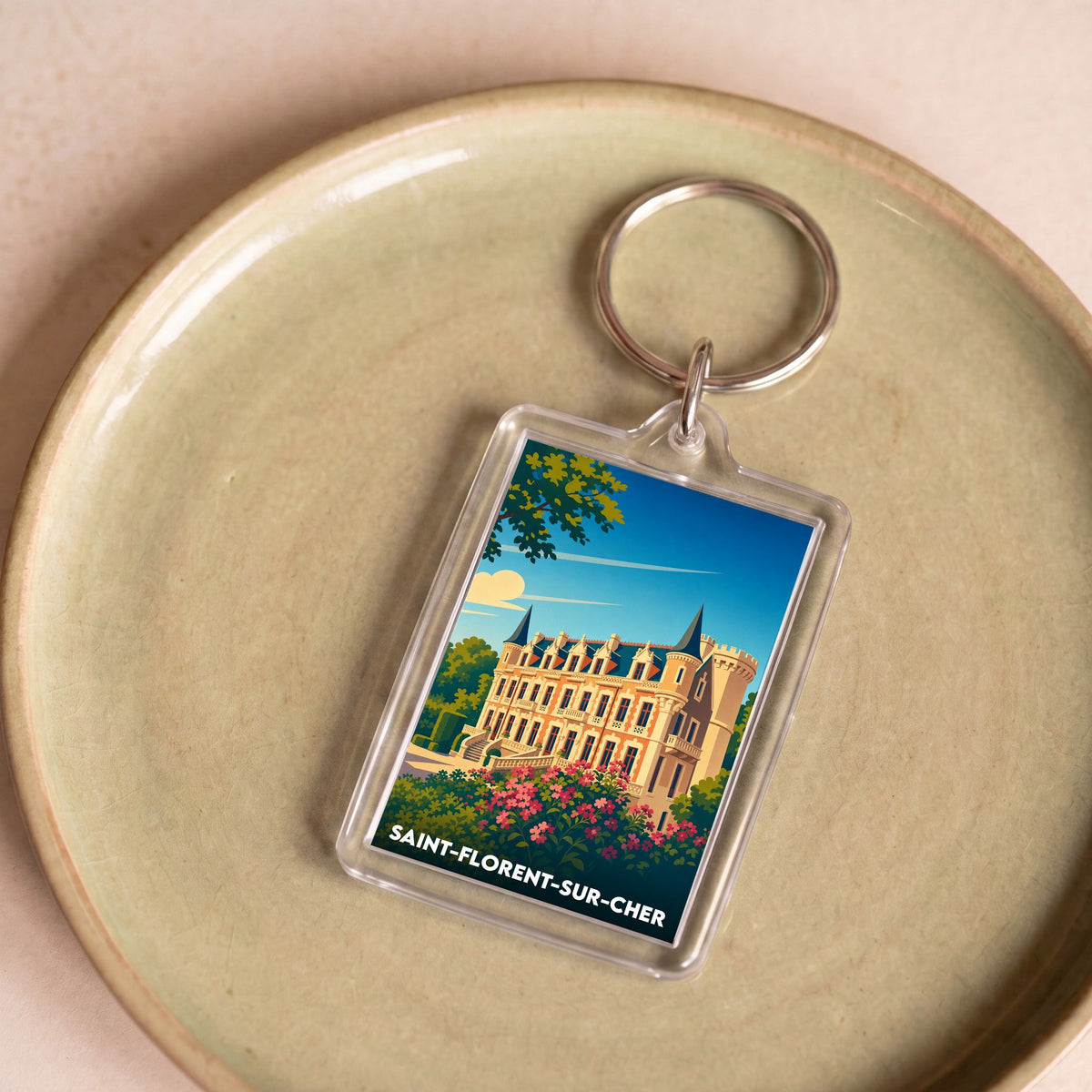 Porte-clés souvenir de la ville de Saint-Florent-sur-Cher avec une illustration stylisée de son château.