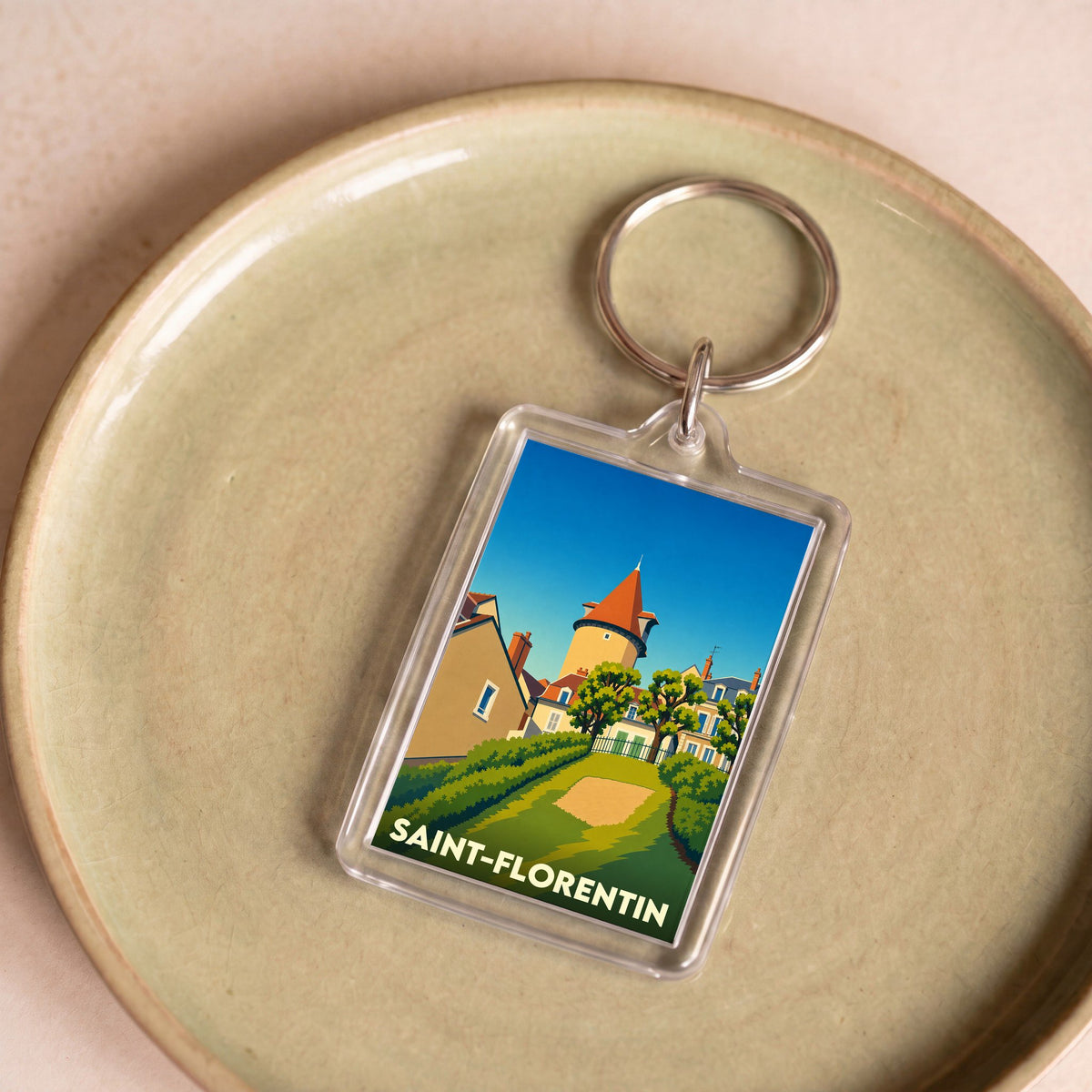 Porte-clés souvenir de la ville de Saint-Florentin avec une illustration stylisée.