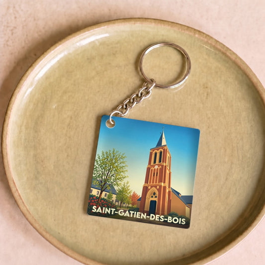 Porte-clés souvenir de la ville de Saint-Gatien-des-Bois avec une illustration stylisée de son église.