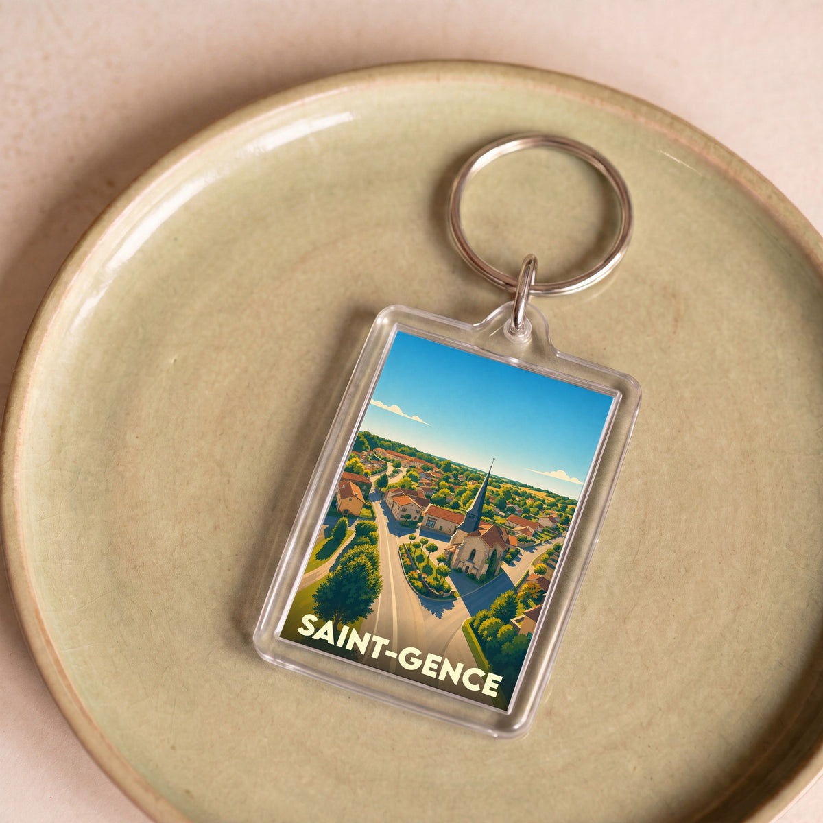Porte-clés souvenir de la ville de Saint-Gence avec une illustration stylisée.