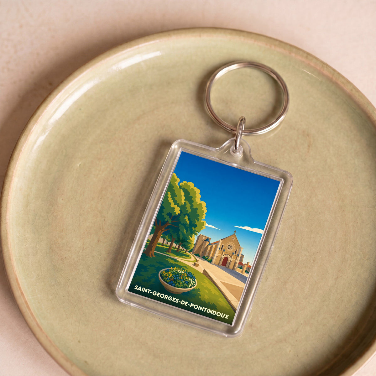 Porte-clés souvenir de la ville de Saint-Georges-de-Pointindoux avec une illustration stylisée.