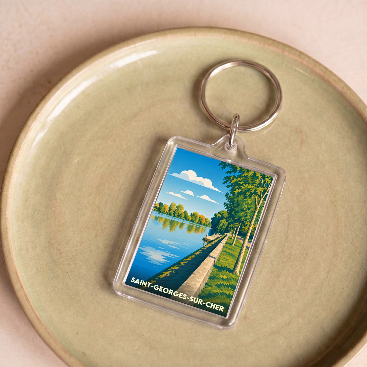Porte-clés souvenir de la ville de Saint-Georges-sur-Cher avec une illustration stylisée des bords du Cher.