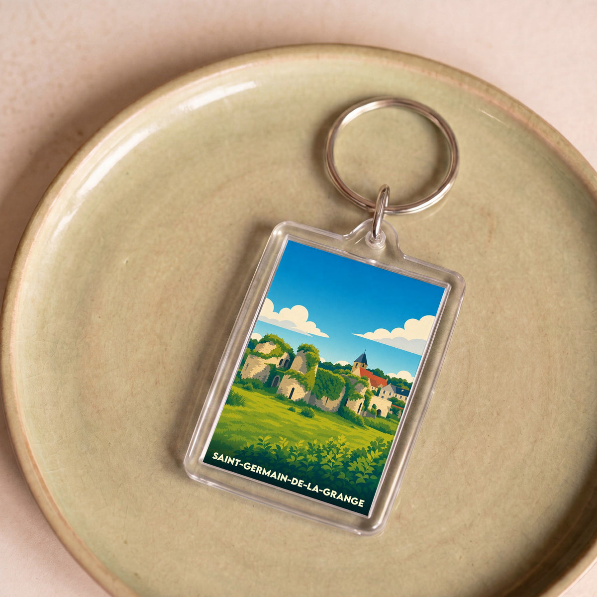 Porte-clés souvenir de la ville de Saint-Germain-de-la-Grange avec une illustration stylisée de ses paysages.